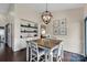 Dining room showcases a wooden table, chandelier, wainscoting, and stylish decor at 4808 Truscott Rd, Charlotte, NC 28226