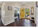 Welcoming foyer with dark wood floors, a decorative chandelier, and a glimpse into the living room at 4808 Truscott Rd, Charlotte, NC 28226