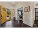 Elegant foyer with dark wood floors, chandelier, and view into the dining room at 4808 Truscott Rd, Charlotte, NC 28226