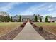 Charming single-story home featuring a well-manicured lawn and inviting yellow front door at 4808 Truscott Rd, Charlotte, NC 28226