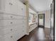 Hallway with window seat, storage and hardwood floors at 4808 Truscott Rd, Charlotte, NC 28226