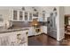 Bright kitchen featuring stainless steel appliances, granite countertops, white cabinets, and hardwood floors at 4808 Truscott Rd, Charlotte, NC 28226