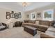 Large living room featuring a sectional, neutral decor, plush carpet, crown molding, and bright natural light at 4808 Truscott Rd, Charlotte, NC 28226