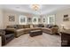 Spacious living room with a large sectional couch, plush carpeting, neutral colors, and bright natural light at 4808 Truscott Rd, Charlotte, NC 28226