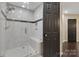 New, tiled shower with bench and glass door in renovated bathroom at 4808 Truscott Rd, Charlotte, NC 28226