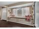 Cozy sitting nook with custom window seat, decorative pillows, and built-in storage cabinets at 4808 Truscott Rd, Charlotte, NC 28226