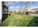 Sprawling backyard featuring a large lawn, playground, and wooden pergola with swing at 5172 Norway Rd, Rock Hill, SC 29732