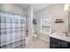 Bathroom with a tub and shower, a toilet, and a sink vanity with black cabinets at 5172 Norway Rd, Rock Hill, SC 29732