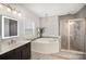 Bathroom features a large tub, double vanity, standalone shower, and large window with natural light at 5172 Norway Rd, Rock Hill, SC 29732