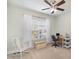 Bright bedroom with a ceiling fan, a rocking chair, and a work station by the window at 5172 Norway Rd, Rock Hill, SC 29732