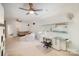 Large bonus room with seating area and crafting or work space; dual ceiling fans overhead at 5172 Norway Rd, Rock Hill, SC 29732