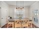 Bright dining room features farmhouse table and chair set, with a door that opens to the outdoors at 5172 Norway Rd, Rock Hill, SC 29732