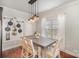 Bright dining room features hardwood floors, rustic farmhouse table and chair set, and modern mason jar lighting fixture at 5172 Norway Rd, Rock Hill, SC 29732