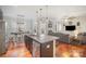 Open-concept kitchen with stainless steel appliances, large island, and hardwood floors at 5172 Norway Rd, Rock Hill, SC 29732