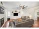Bright living room with hardwood floors, modern ceiling fan, and comfortable gray couches at 5172 Norway Rd, Rock Hill, SC 29732