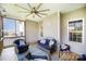 Comfortable screened porch featuring blue cushioned wicker seating and a ceiling fan at 5172 Norway Rd, Rock Hill, SC 29732
