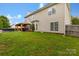 Spacious backyard featuring a covered patio, ample green space, and a swimming pool for outdoor enjoyment at 5519 Burning Ridge Dr, Monroe, NC 28110