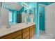 Bright bathroom features double sinks, wood cabinetry, and ample storage with modern light fixtures at 5519 Burning Ridge Dr, Monroe, NC 28110