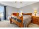 Comfortable bedroom featuring wood furniture, soft lighting, and a tray ceiling at 5519 Burning Ridge Dr, Monroe, NC 28110