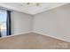 Bright bedroom with neutral walls and carpeted floors with a window for natural light at 5519 Burning Ridge Dr, Monroe, NC 28110
