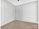 A bright, carpeted bedroom featuring neutral walls and flooring at 5519 Burning Ridge Dr, Monroe, NC 28110