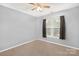 Carpeted bedroom with neutral paint, a window for natural light and ceiling fan at 5519 Burning Ridge Dr, Monroe, NC 28110