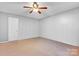 Empty bedroom with a ceiling fan and neutral carpet at 5519 Burning Ridge Dr, Monroe, NC 28110
