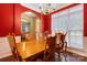 Bright dining room with red walls, wood table and chairs, and ample natural light at 5519 Burning Ridge Dr, Monroe, NC 28110
