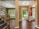 Inviting foyer with hardwood floors, staircase, and views into the living spaces, creating a warm welcome at 5519 Burning Ridge Dr, Monroe, NC 28110