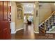 Inviting foyer with hardwood floors, staircase, and views into the living spaces, creating a warm welcome at 5519 Burning Ridge Dr, Monroe, NC 28110