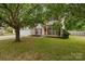 Charming two-story home featuring vinyl siding, red shutters, landscaped yard, and an attached two-car garage at 5519 Burning Ridge Dr, Monroe, NC 28110