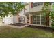 Charming two-story home with white siding, red shutters, and an attached two-car garage at 5519 Burning Ridge Dr, Monroe, NC 28110