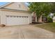 Charming two-story home featuring vinyl siding, red shutters, landscaped yard, and an attached two-car garage at 5519 Burning Ridge Dr, Monroe, NC 28110