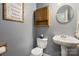 Cozy half bath with pedestal sink, framed art and neutral wall color at 5519 Burning Ridge Dr, Monroe, NC 28110