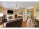 Bright living room includes a fireplace, ceiling fan, and view into the entry at 5519 Burning Ridge Dr, Monroe, NC 28110