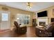 Cozy living room with hardwood floors, natural light, comfortable seating, and a fireplace at 5519 Burning Ridge Dr, Monroe, NC 28110