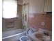 Bathroom featuring a bathtub, toilet, and a sink at 605 W Elm St, Shelby, NC 28150