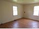 Empty bedroom showcasing laminate flooring and natural light from two windows at 605 W Elm St, Shelby, NC 28150