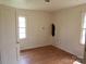 Empty bedroom with laminate flooring, and natural light from two windows at 605 W Elm St, Shelby, NC 28150