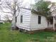 View of the house's side, showing the utility connections, siding, and windows at 605 W Elm St, Shelby, NC 28150