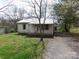 Charming single-story house with driveway and mature trees around the property at 605 W Elm St, Shelby, NC 28150