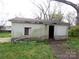 Exterior of garage building with an overgrown lawn needs care at 605 W Elm St, Shelby, NC 28150