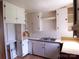 Kitchen with white cabinets, double basin sink and laminate countertops at 605 W Elm St, Shelby, NC 28150