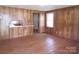 Open living area featuring wood paneled walls and wood flooring at 605 W Elm St, Shelby, NC 28150