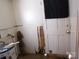 Damaged storage room with peeling wall, water heater and unfinished doorway needs repair at 605 W Elm St, Shelby, NC 28150