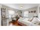 Light-filled bedroom with a bed, rocking chair, and charming decor at 608 Forney Ave, Lincolnton, NC 28092