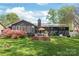 Charming home backyard with wooden deck, beautiful flower bush, and green lawn for outdoor enjoyment at 6100 Rose Valley Dr, Charlotte, NC 28210