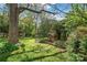 Charming backyard featuring playhouses, a swing, and lush landscaping, creating a delightful play area at 6100 Rose Valley Dr, Charlotte, NC 28210