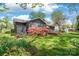 Backyard featuring a wooden deck, lush greenery, and vibrant pink azaleas for a serene outdoor retreat at 6100 Rose Valley Dr, Charlotte, NC 28210