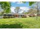 Well-manicured lawn and charming exterior of single story home with cozy front porch at 6100 Rose Valley Dr, Charlotte, NC 28210